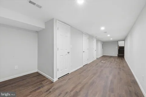 a view of a room with wooden floor