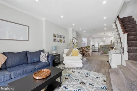 a living room with furniture kitchen view and a table