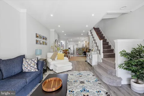 a living room with furniture and a potted plant