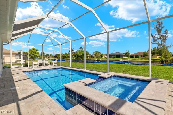 a view of a backyard with swimming pool