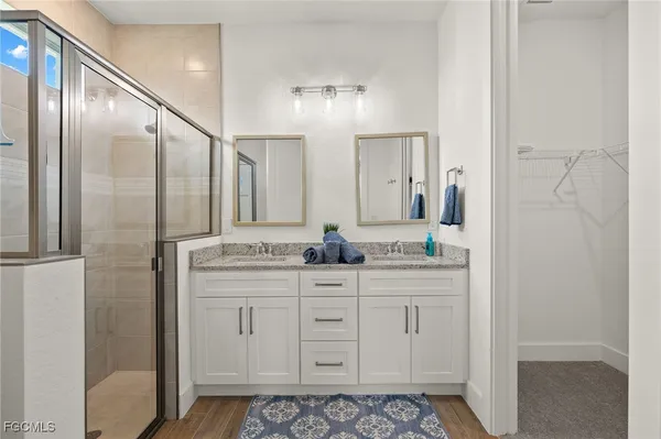 a bathroom with a granite countertop sink a mirror and a