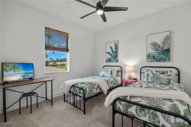 a bedroom with two beds and a desk