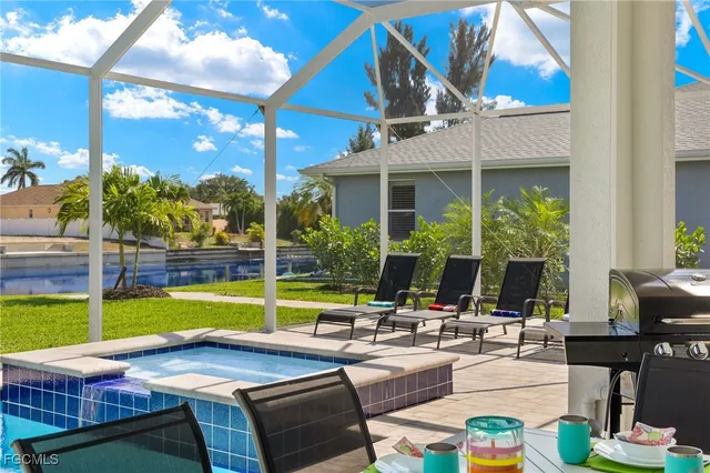 a view of a patio with couches table and chairs and potted plants