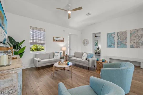 a living room with furniture and a wooden floor