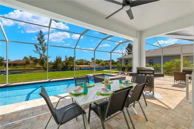 a view of a dining room with furniture and floor to ceiling window