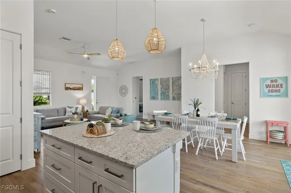 a kitchen with a table chairs and a chandelier