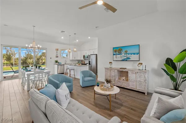a living room with furniture and a wooden floor