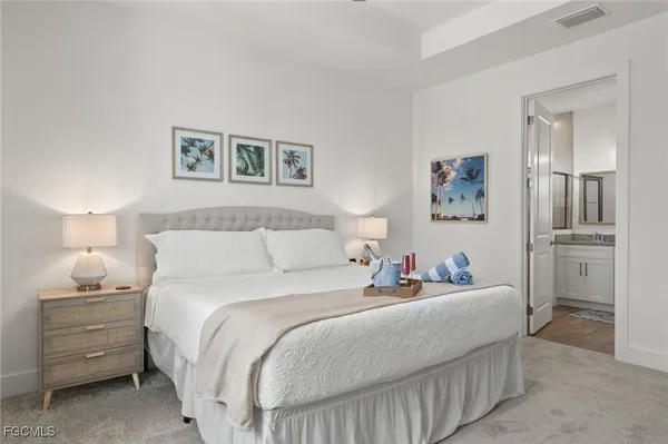 a bedroom with a bed and a night stand