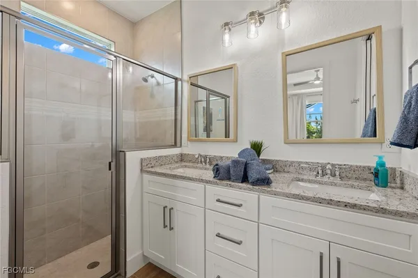 a bathroom with double sink and a mirror