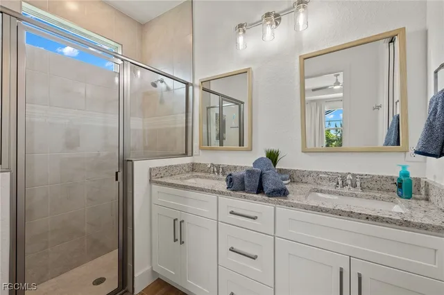 a bathroom with double sink and a mirror