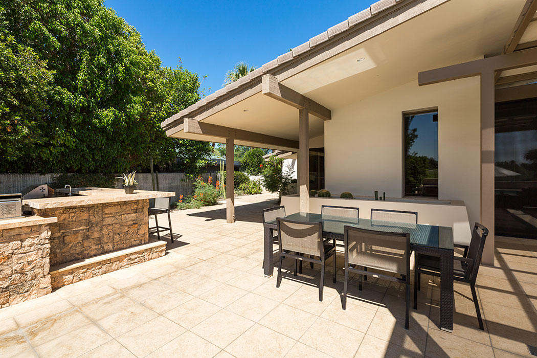 12 Avenida Andra Palm Desert, CA 92260 - Photo 14 of 42 a view of a patio with a table and chairs under an umbrella