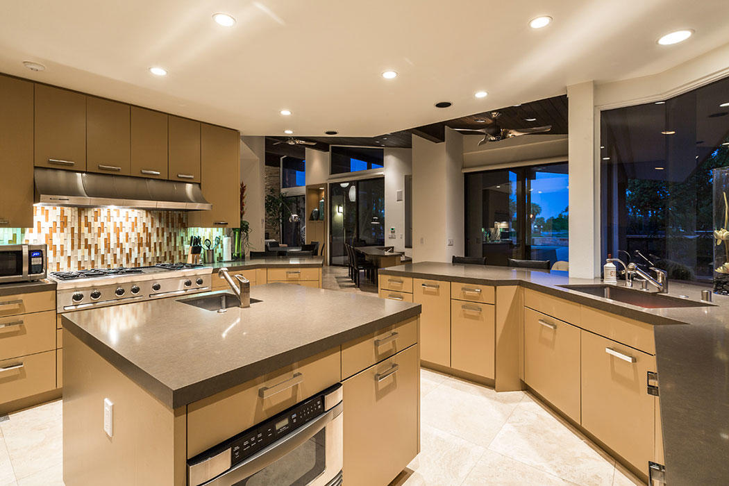12 Avenida Andra Palm Desert, CA 92260 - Photo 21 of 42 a kitchen with a stove a sink and a refrigerator