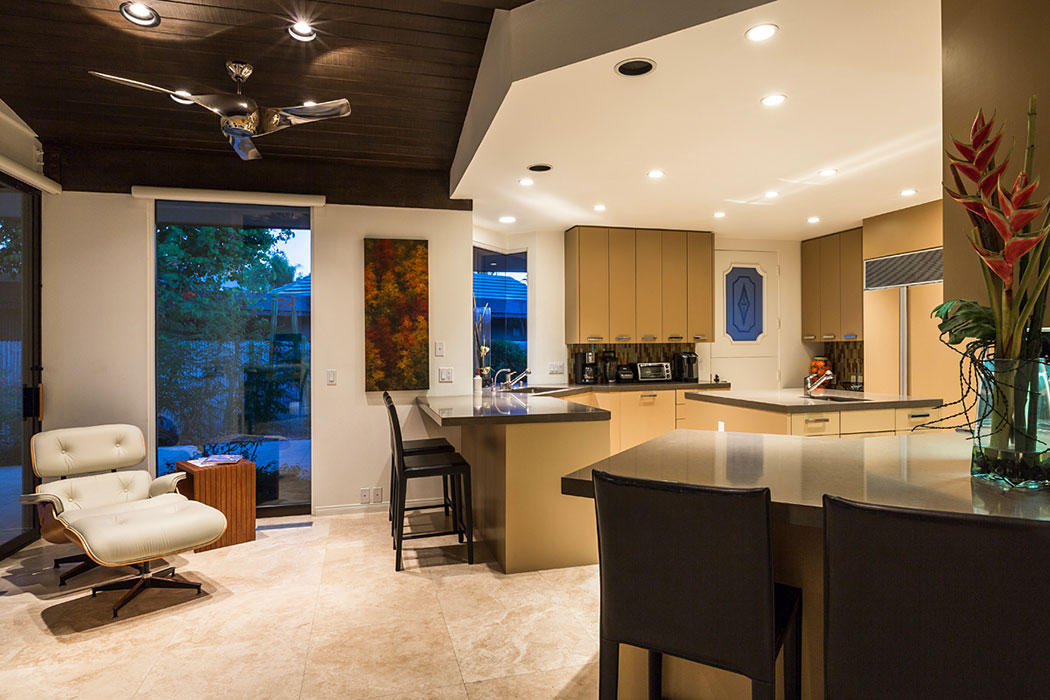 12 Avenida Andra Palm Desert, CA 92260 - Photo 22 of 42 a kitchen with a dining table chairs sink and granite counter top