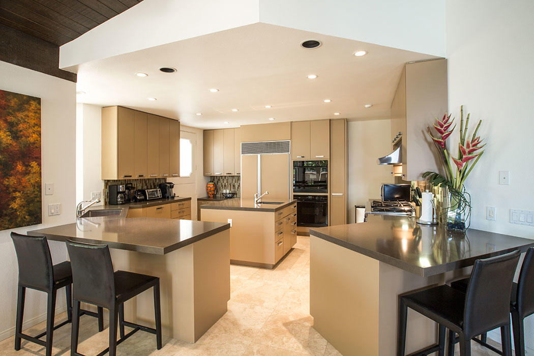 12 Avenida Andra Palm Desert, CA 92260 - Photo 24 of 42 a kitchen with sink a refrigerator and chairs