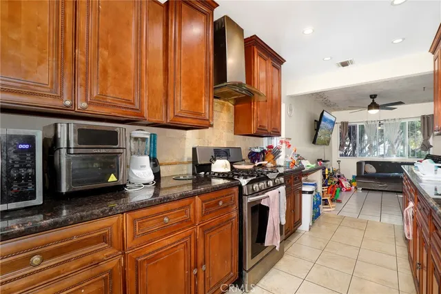 a kitchen with stainless steel appliances granite countertop a stove a sink and a microwave