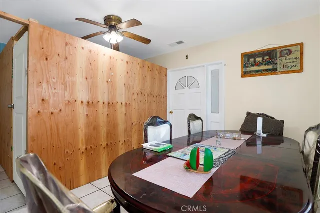 a view of a dining room with furniture a rug and a chandelier