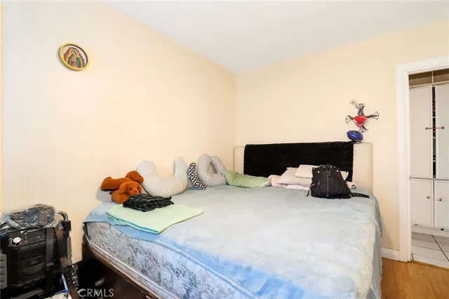 a bedroom with a bed and a potted plant