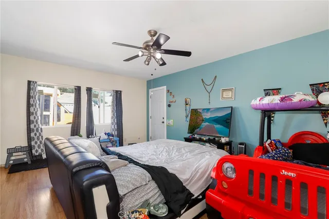 a bedroom with two beds and a chandelier