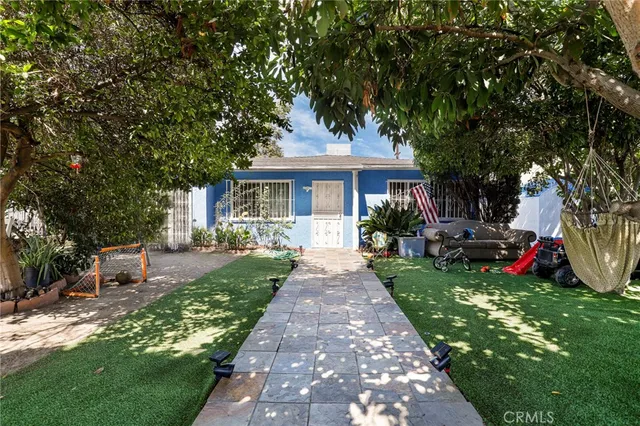 a front view of a house with a garden