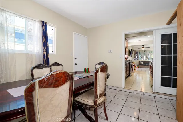 a living room with furniture a flat screen tv and view of kitchen