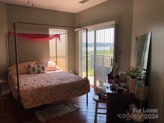 1328 Torrence Circle Davidson, NC 28036 - Photo 13 of 34 a bedroom with a bed table flowerpot and window