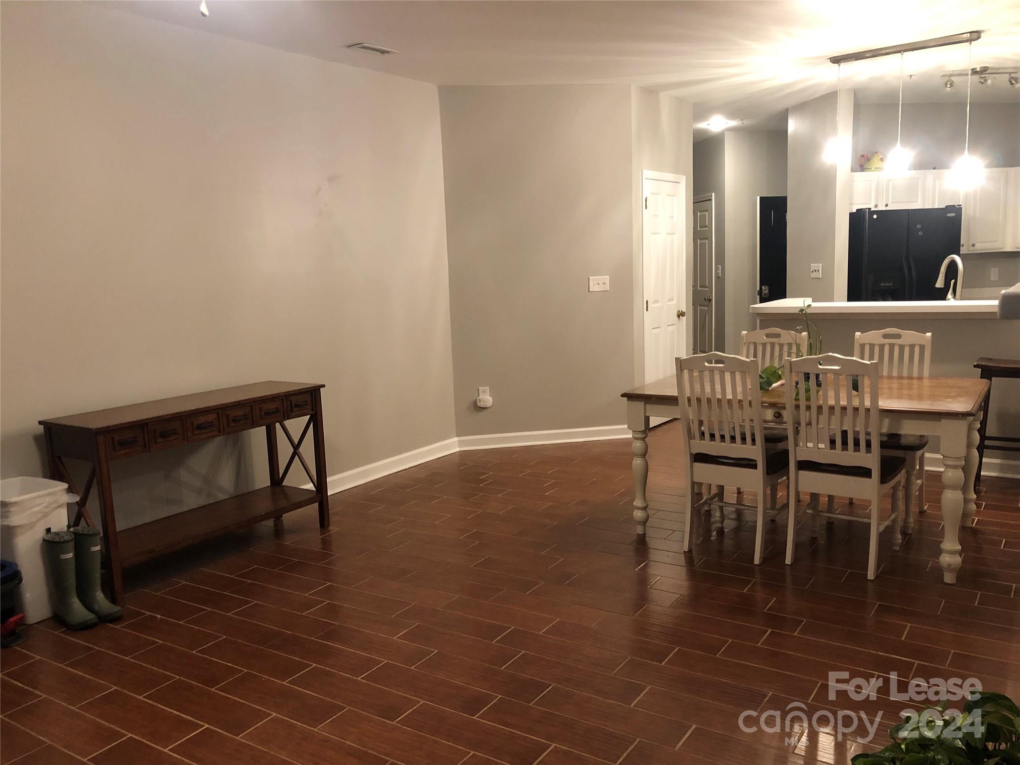 1328 Torrence Circle Davidson, NC 28036 - Photo 23 of 34 a view of a dining room with furniture and wooden floor