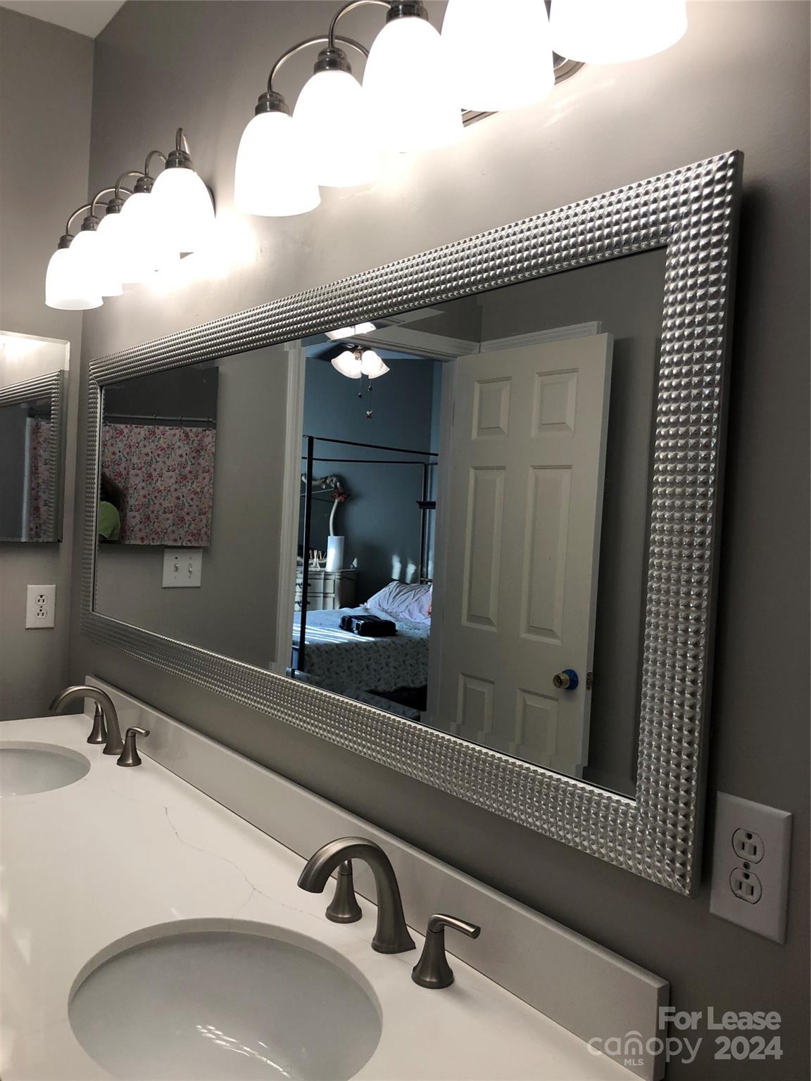 1328 Torrence Circle Davidson, NC 28036 - Photo 34 of 34 a bathroom with a sink and a mirror