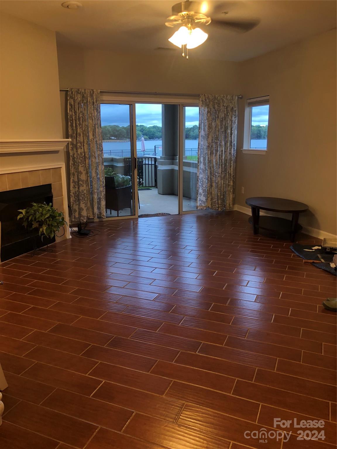 1328 Torrence Circle Davidson, NC 28036 - Photo 7 of 34 an empty room with floor to ceiling window and fire place