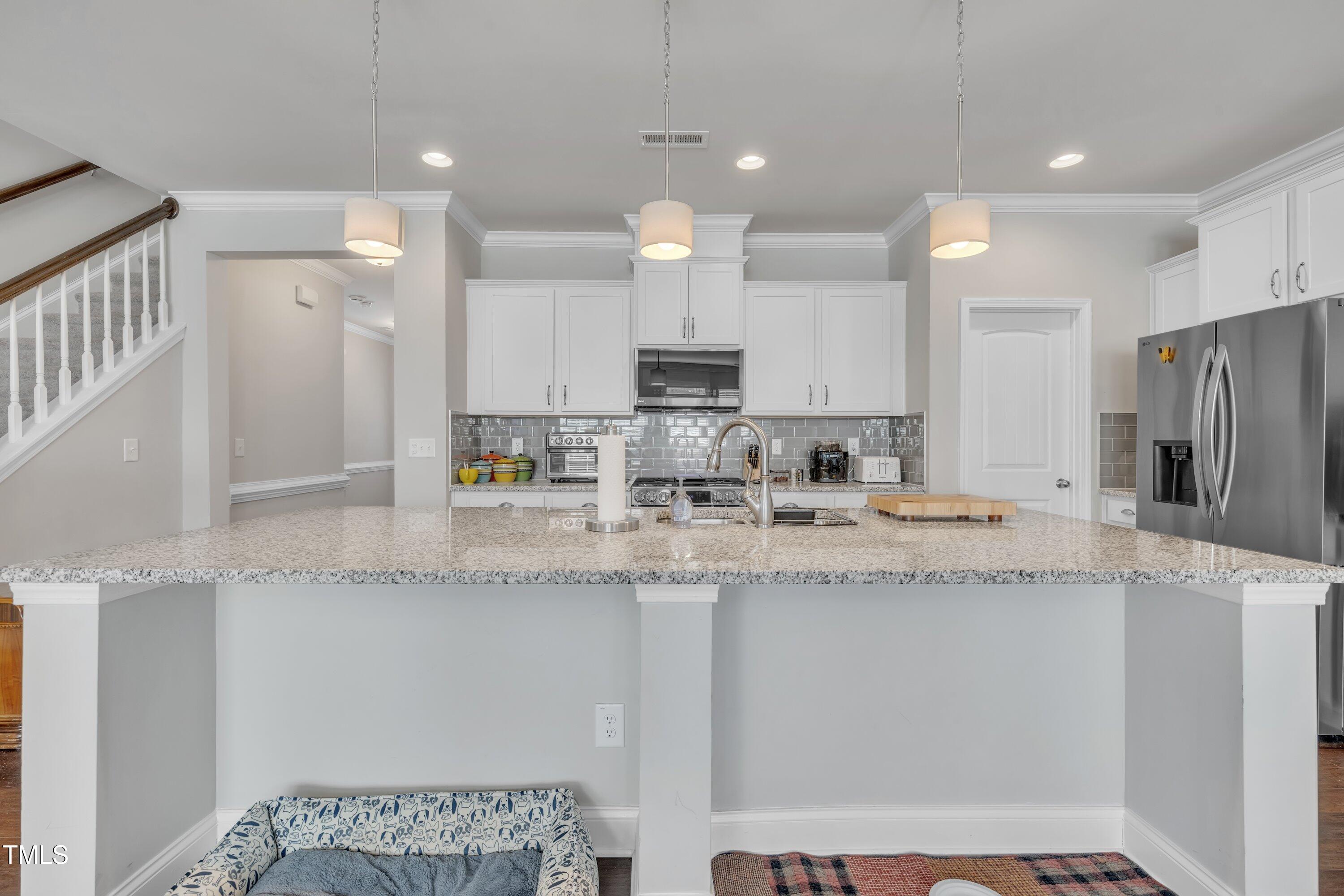 640 Newlyn Drive Raleigh, NC 27606 - Photo 11 of 44 a kitchen with stainless steel appliances granite countertop a sink refrigerator and cabinets