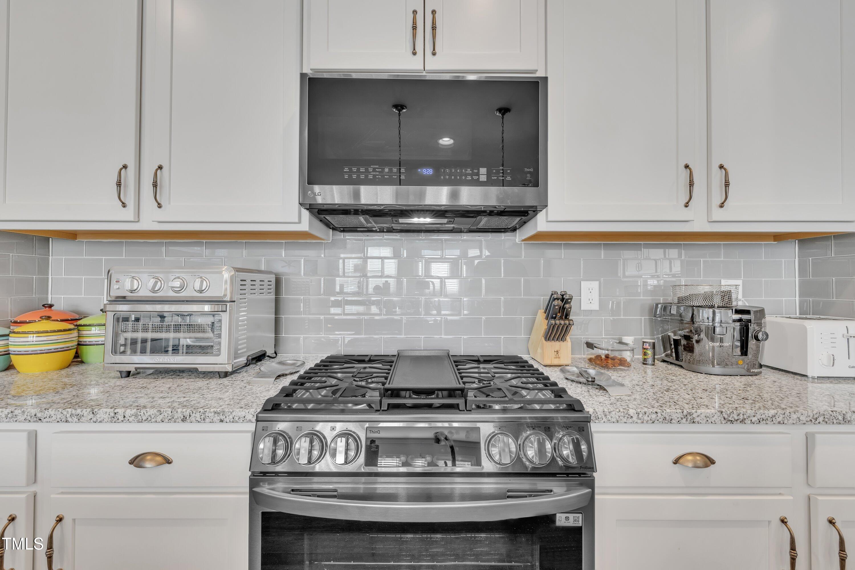 640 Newlyn Drive Raleigh, NC 27606 - Photo 14 of 44 a stove top oven sitting inside of a kitchen