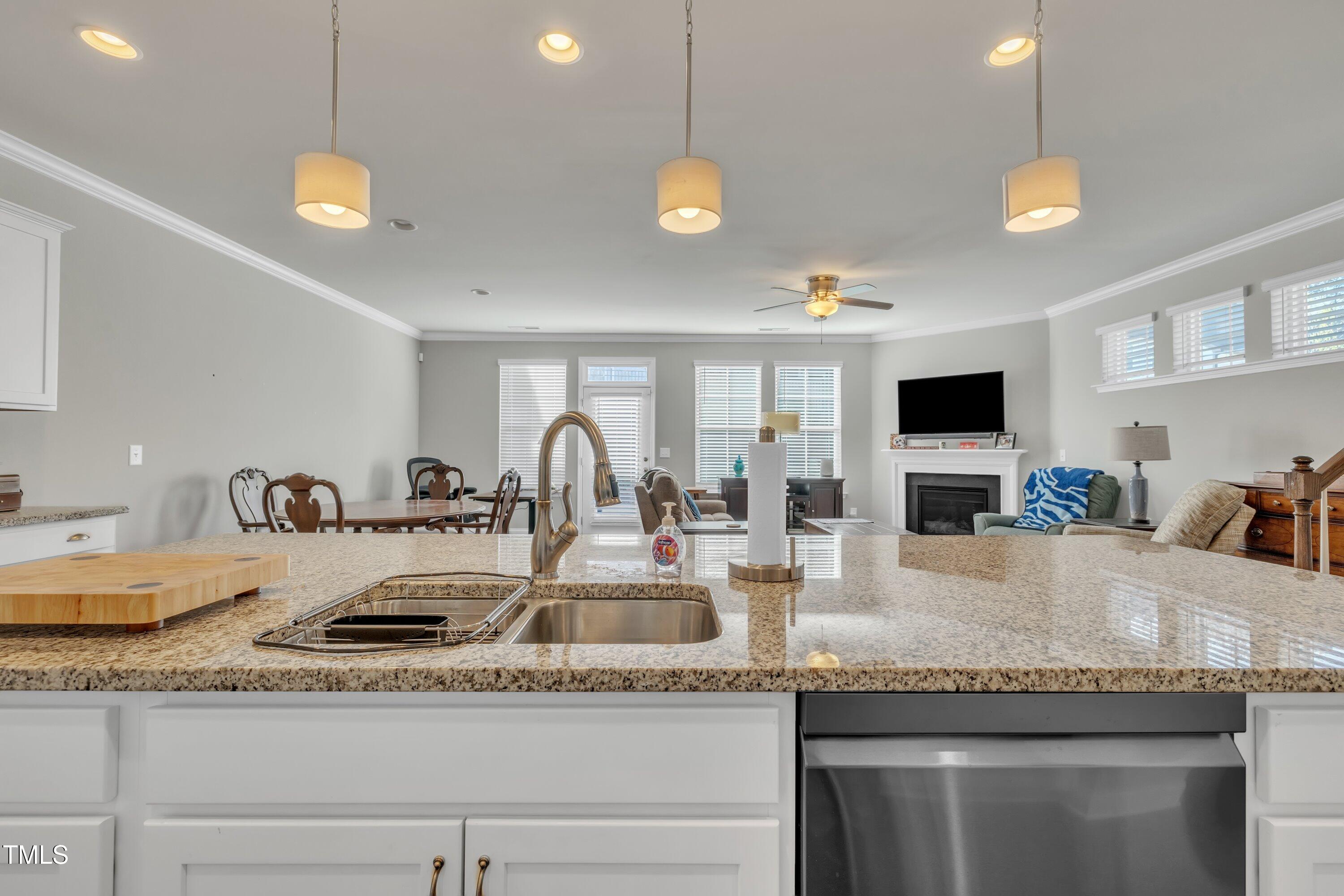 640 Newlyn Drive Raleigh, NC 27606 - Photo 15 of 44 a kitchen with granite countertop a sink and chandelier