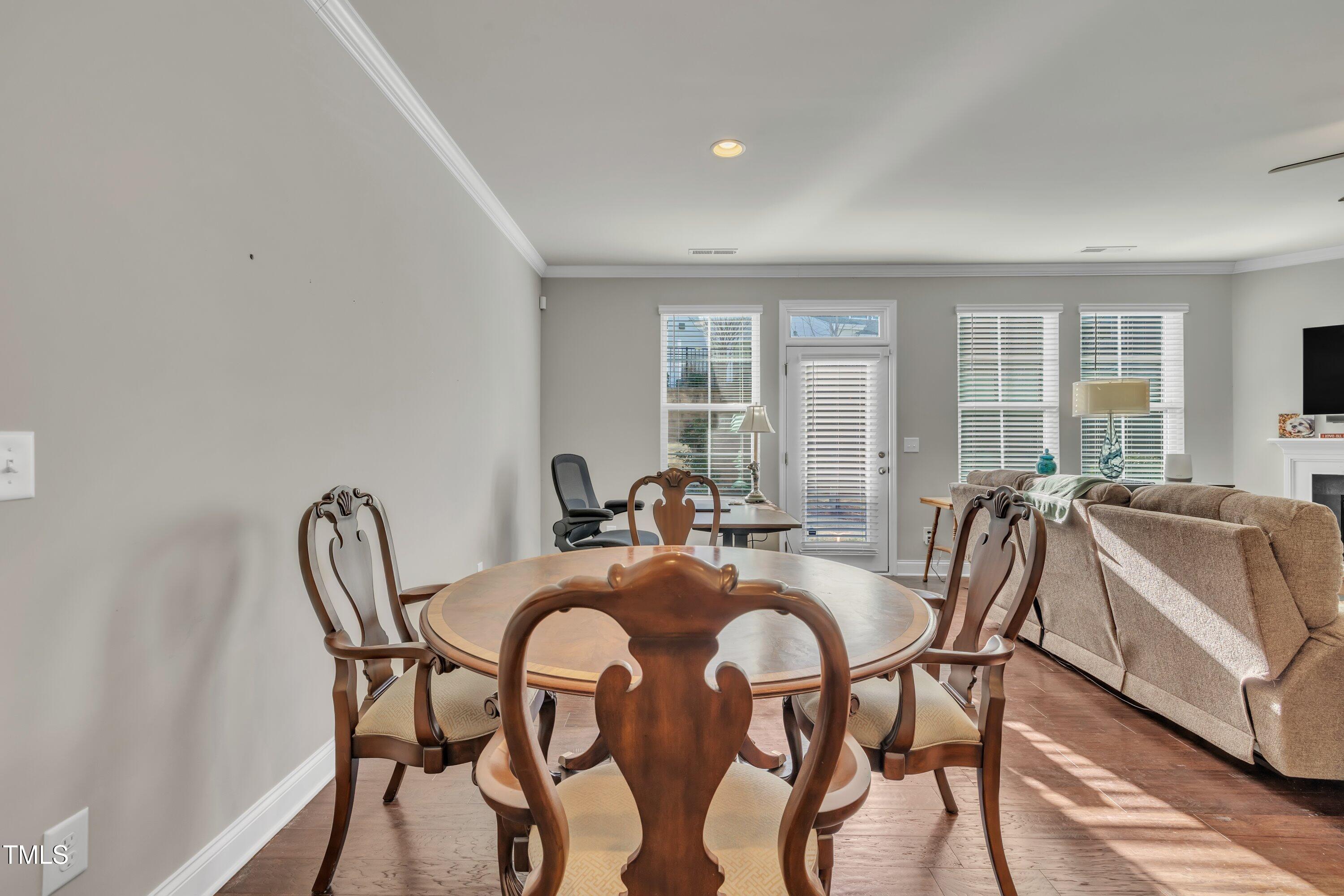 640 Newlyn Drive Raleigh, NC 27606 - Photo 16 of 44 a view of a dining room with furniture and windows