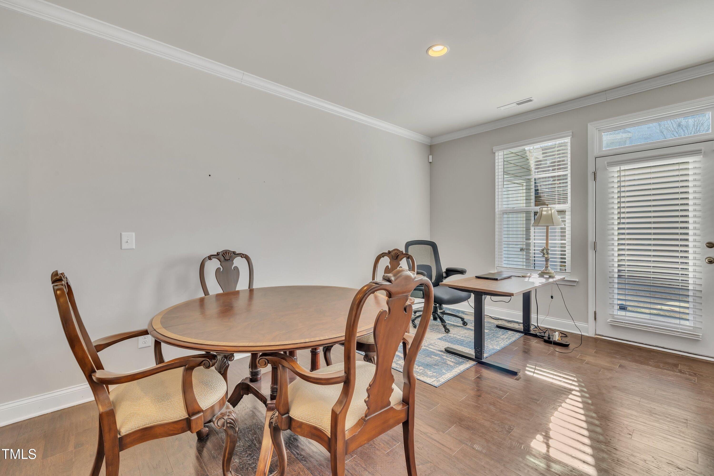 640 Newlyn Drive Raleigh, NC 27606 - Photo 17 of 44 a view of a dining room with furniture and wooden floor