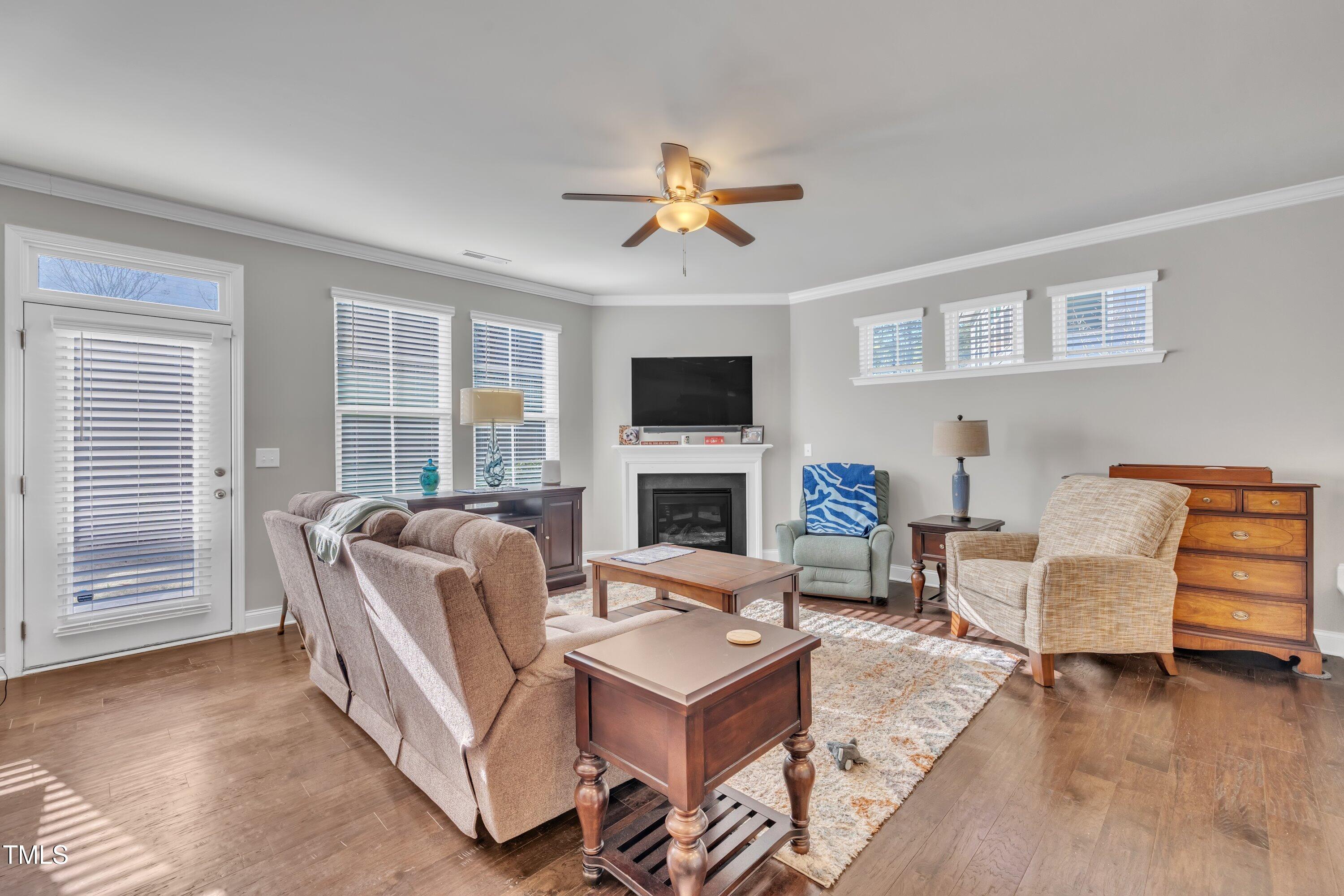 640 Newlyn Drive Raleigh, NC 27606 - Photo 18 of 44 a living room with furniture a fireplace and a flat screen tv