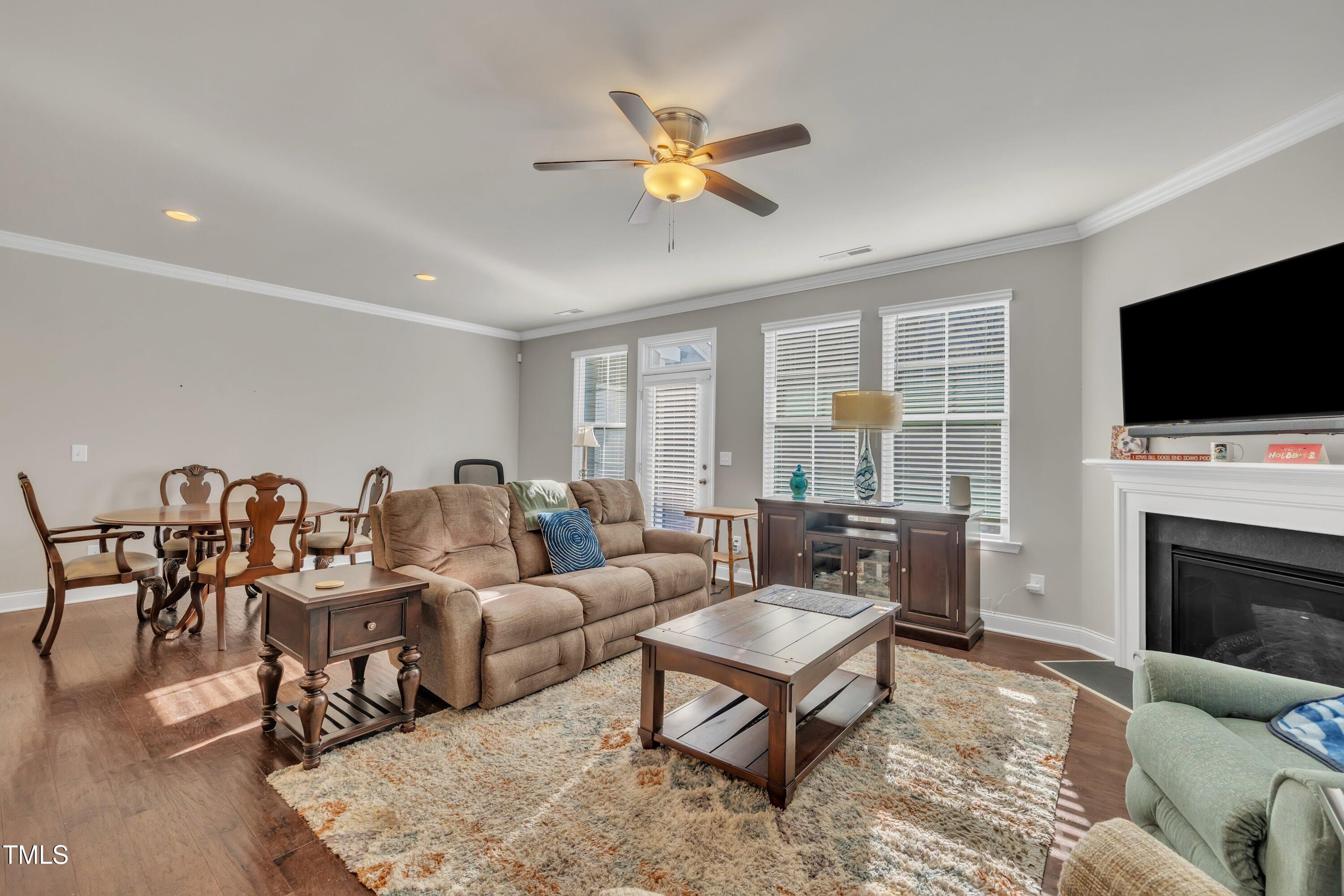 640 Newlyn Drive Raleigh, NC 27606 - Photo 19 of 44 a living room with furniture a fireplace and a flat screen tv