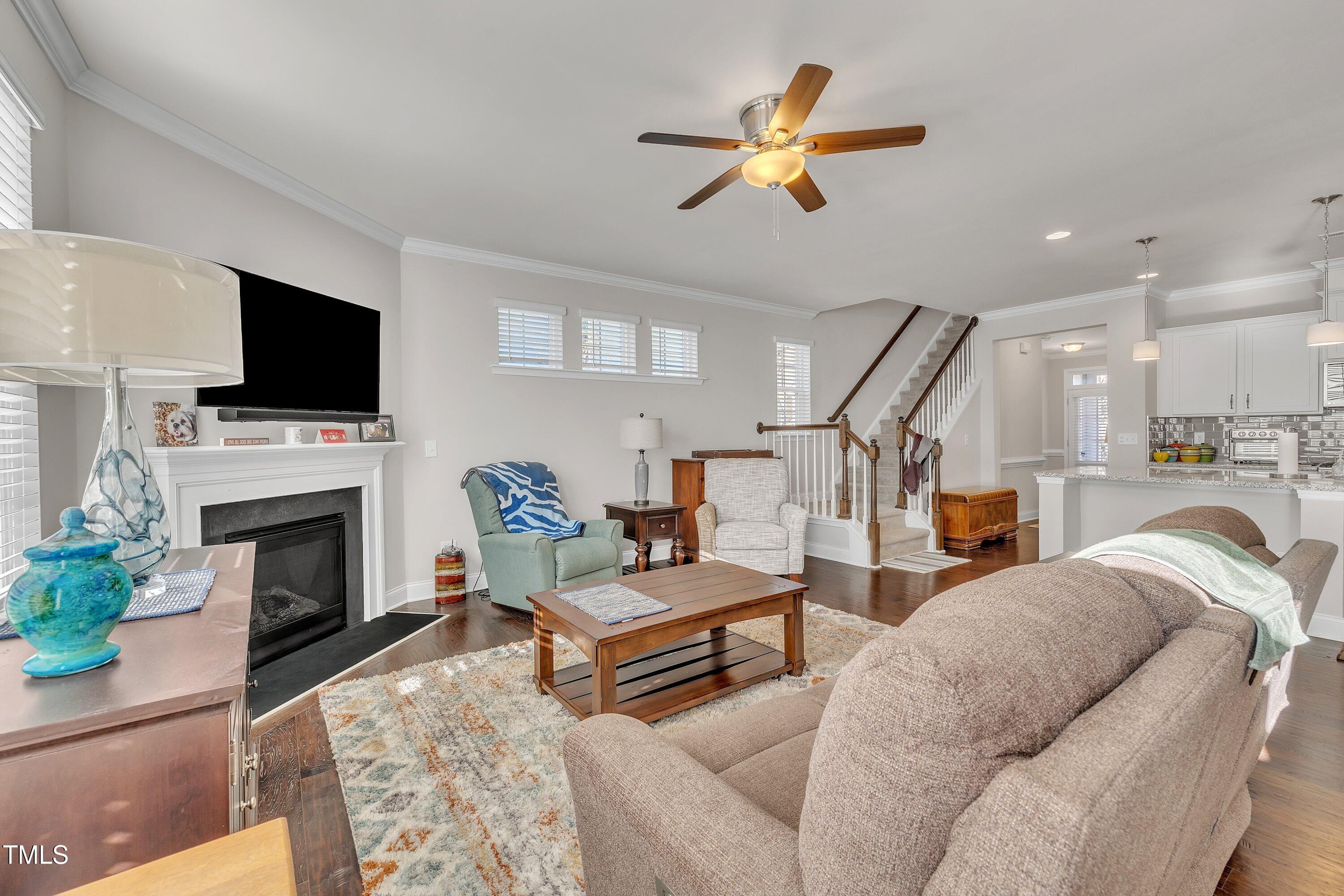 640 Newlyn Drive Raleigh, NC 27606 - Photo 21 of 44 a living room with furniture a fireplace and a flat screen tv