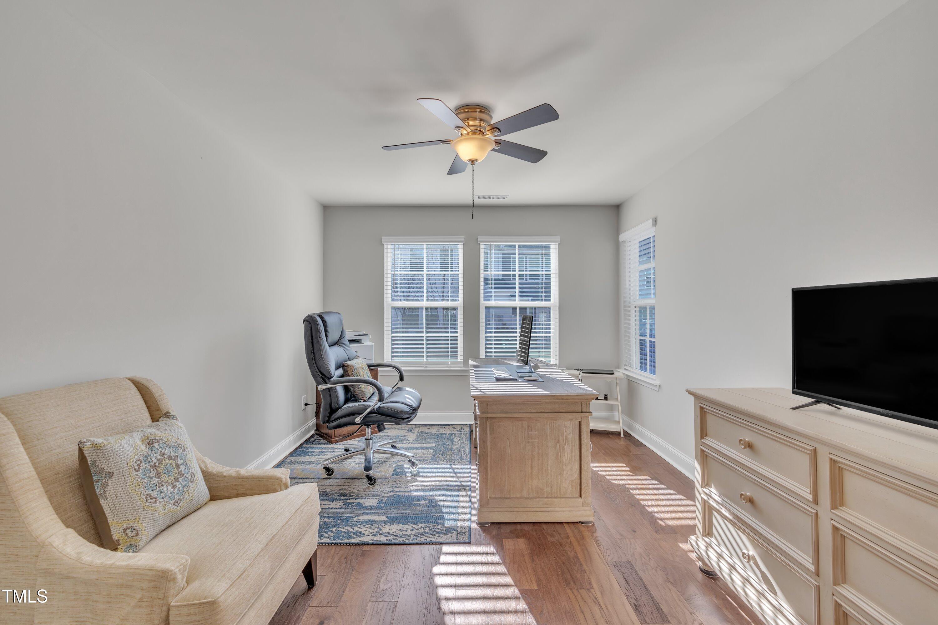 640 Newlyn Drive Raleigh, NC 27606 - Photo 23 of 44 a living room with furniture and a flat screen tv