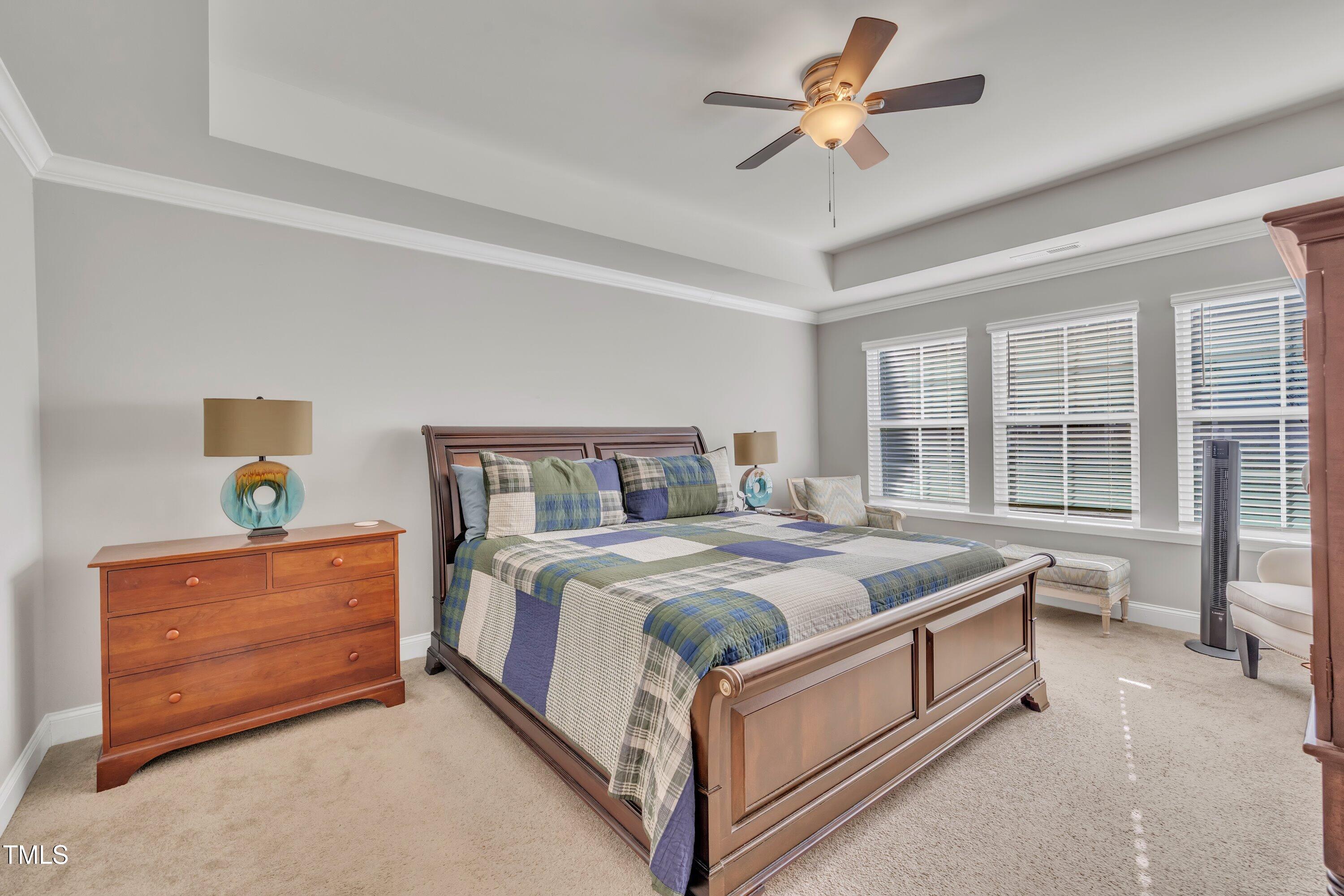 640 Newlyn Drive Raleigh, NC 27606 - Photo 24 of 44 a bed sitting in a bedroom next to a window and a chandelier