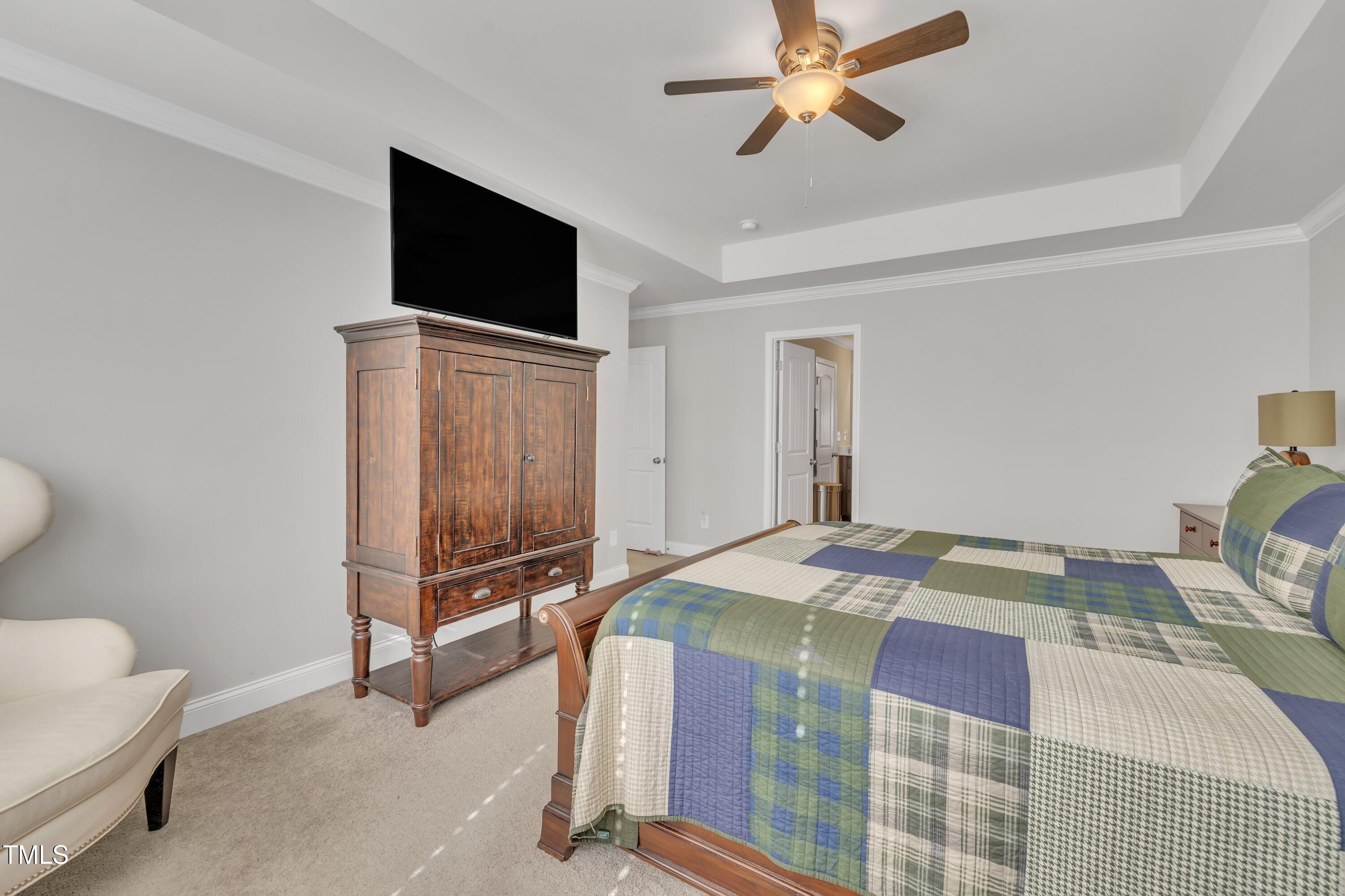 640 Newlyn Drive Raleigh, NC 27606 - Photo 26 of 44 a bedroom with a bed and a flat screen tv