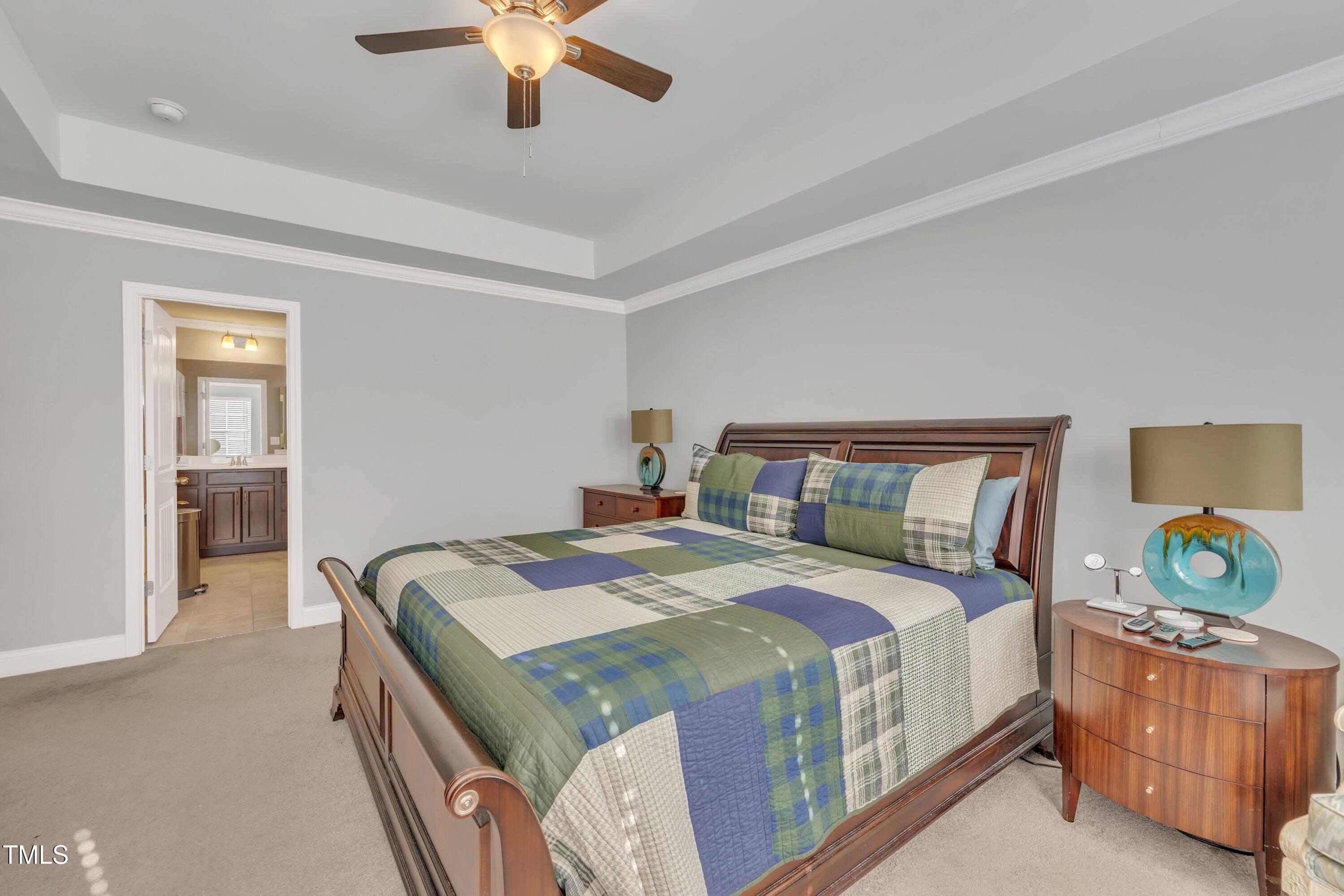 640 Newlyn Drive Raleigh, NC 27606 - Photo 27 of 44 a bedroom with a bed and a chandelier