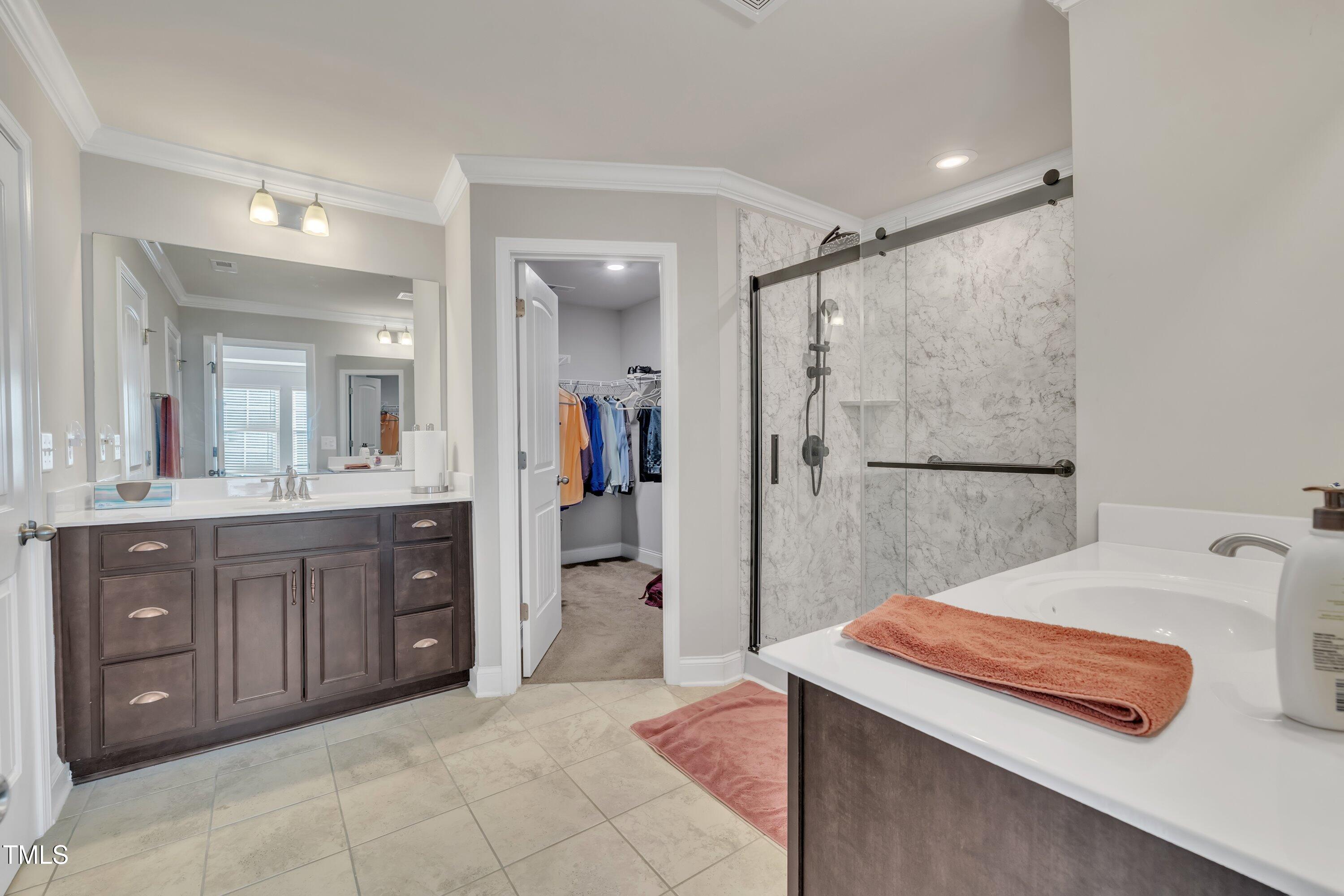640 Newlyn Drive Raleigh, NC 27606 - Photo 28 of 44 a bathroom with a tub sink and mirror