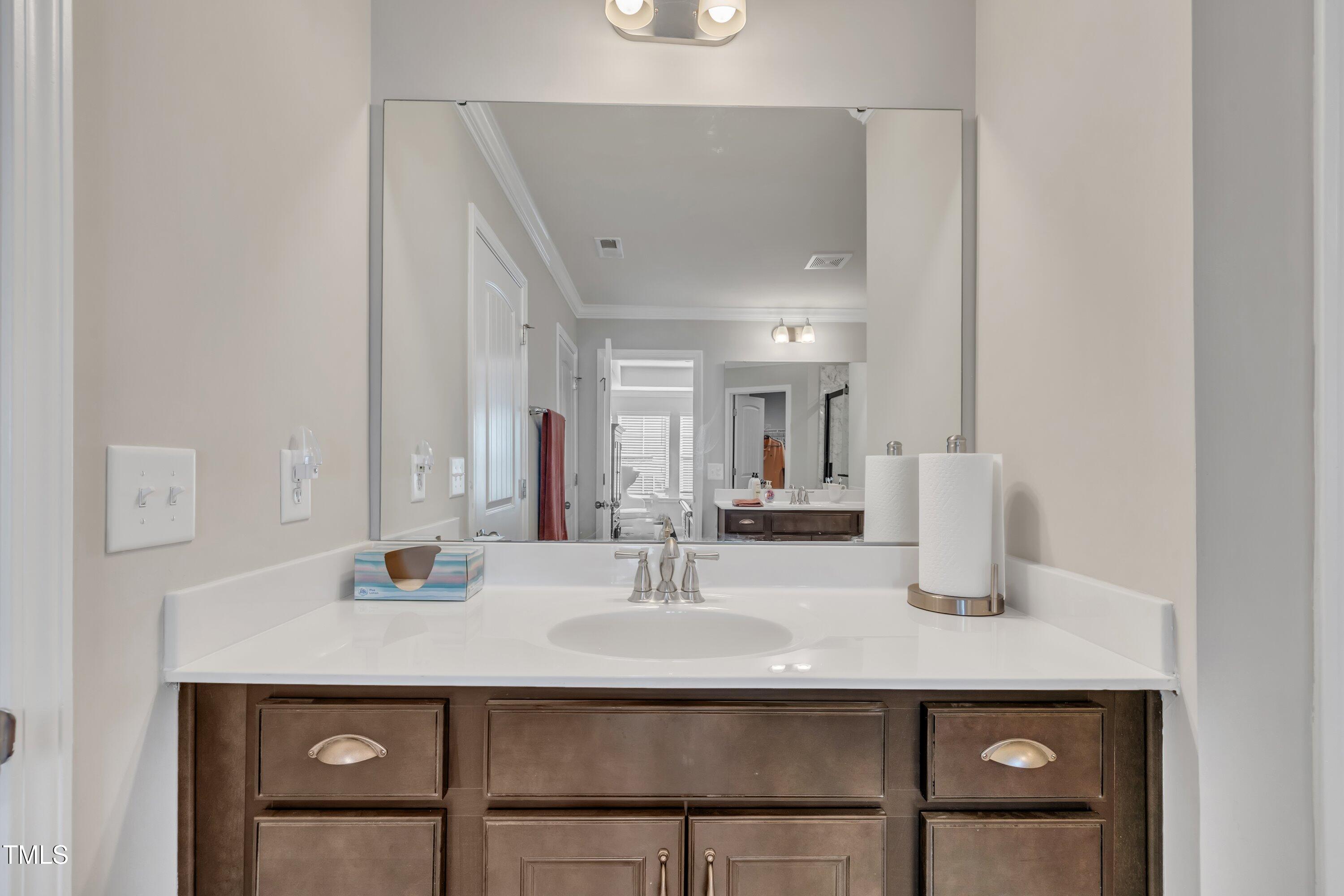 640 Newlyn Drive Raleigh, NC 27606 - Photo 30 of 44 a bathroom with a sink and a mirror