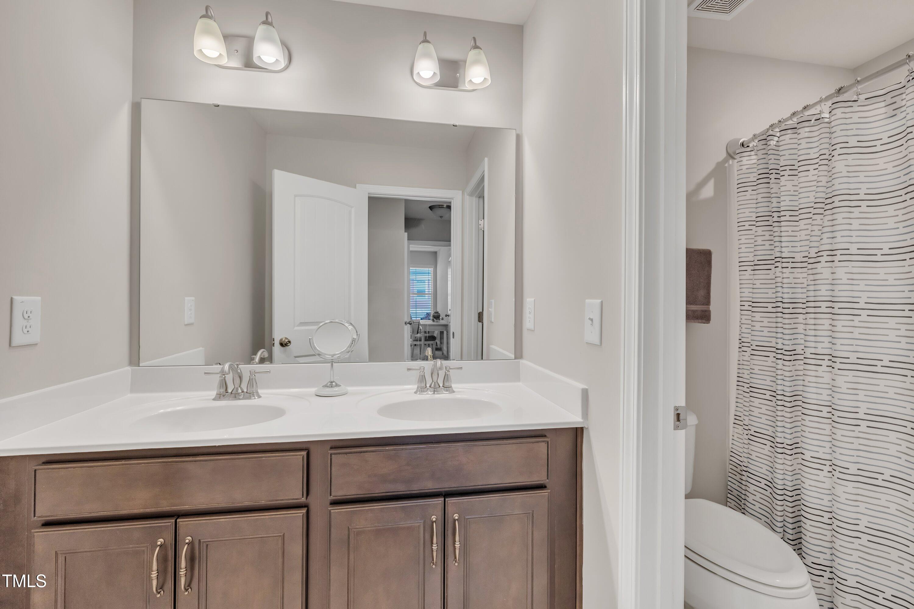 640 Newlyn Drive Raleigh, NC 27606 - Photo 31 of 44 a bathroom with a sink vanity granite and toilet