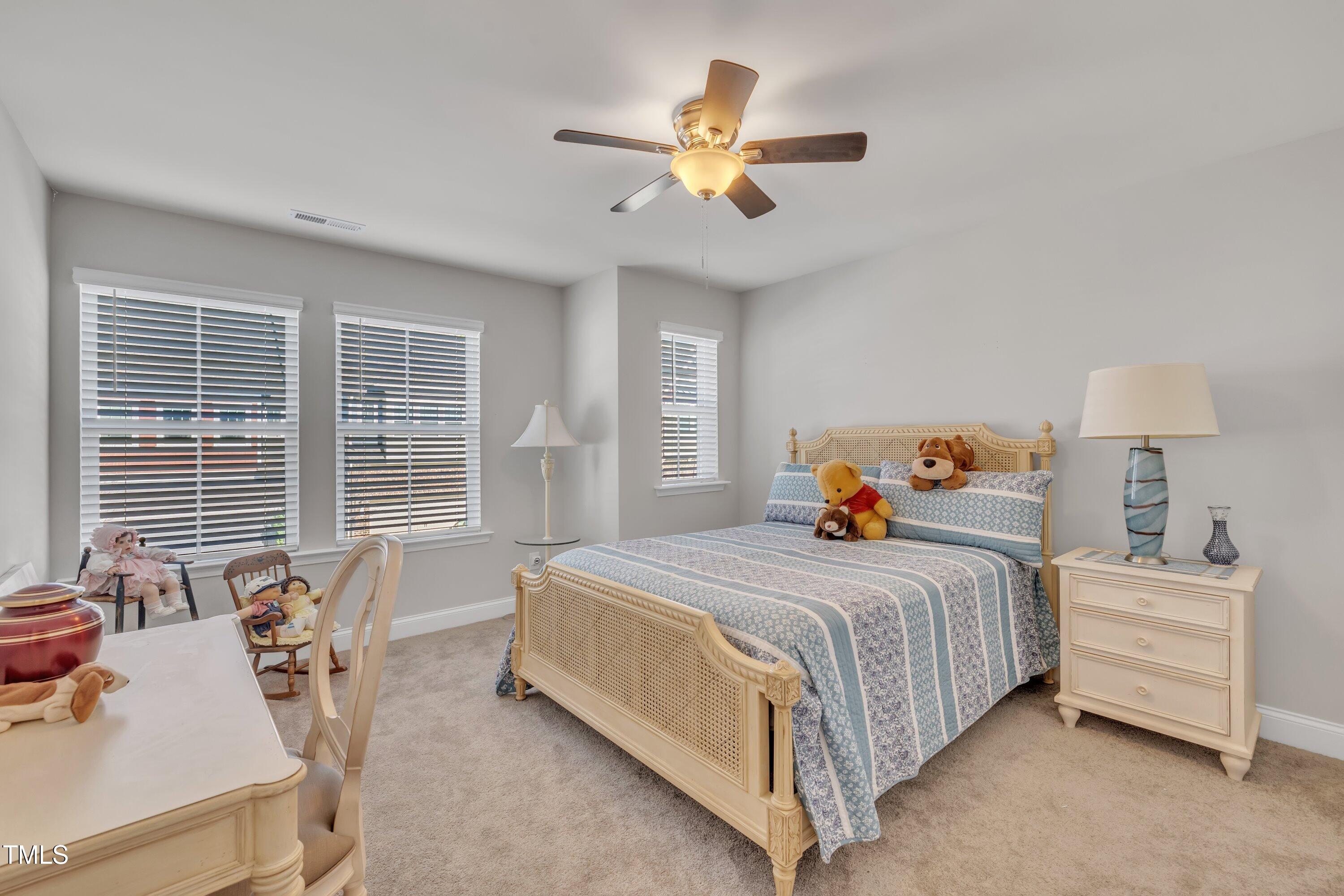 640 Newlyn Drive Raleigh, NC 27606 - Photo 33 of 44 a bedroom with a bed and a large window