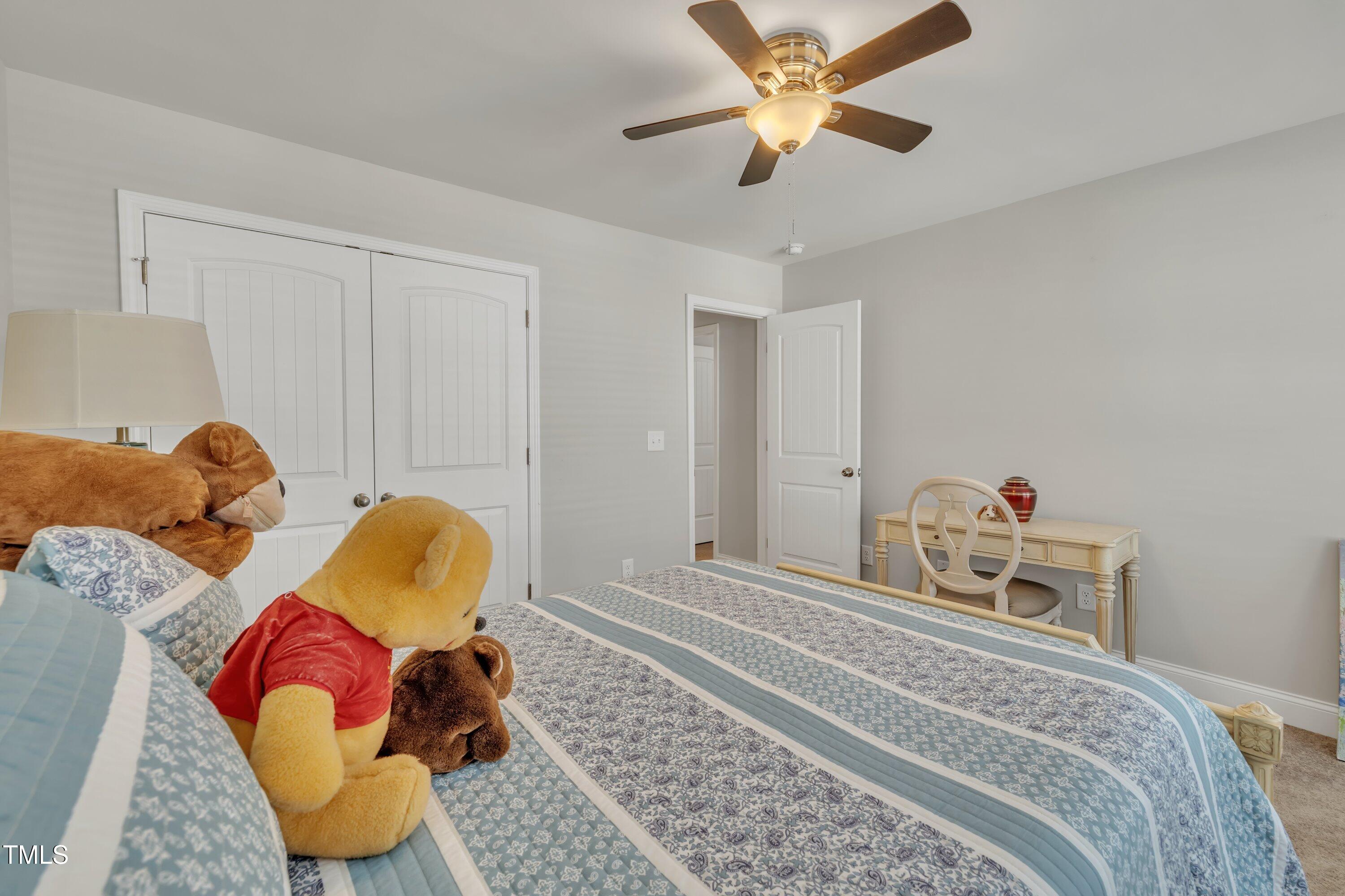 640 Newlyn Drive Raleigh, NC 27606 - Photo 34 of 44 a bedroom with a bed and a chandelier