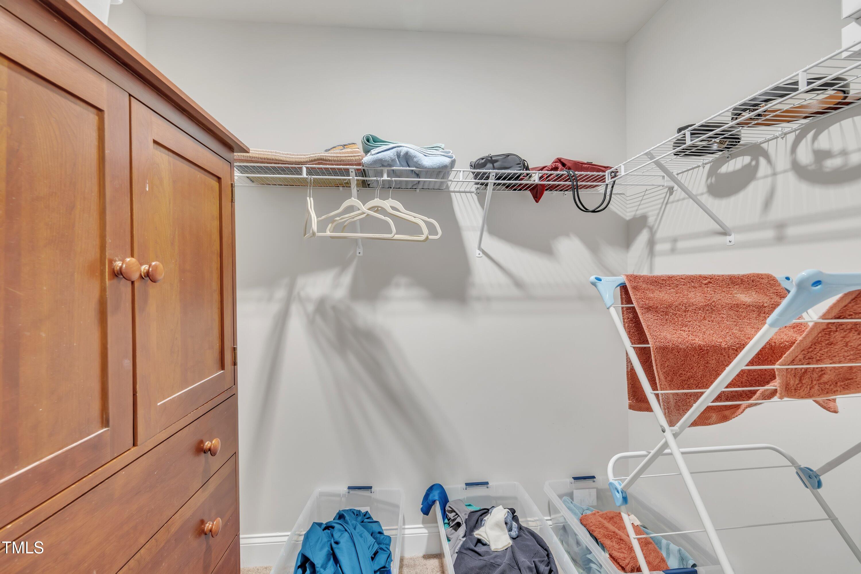 640 Newlyn Drive Raleigh, NC 27606 - Photo 37 of 44 a view of storage and utility room with racks on the wall