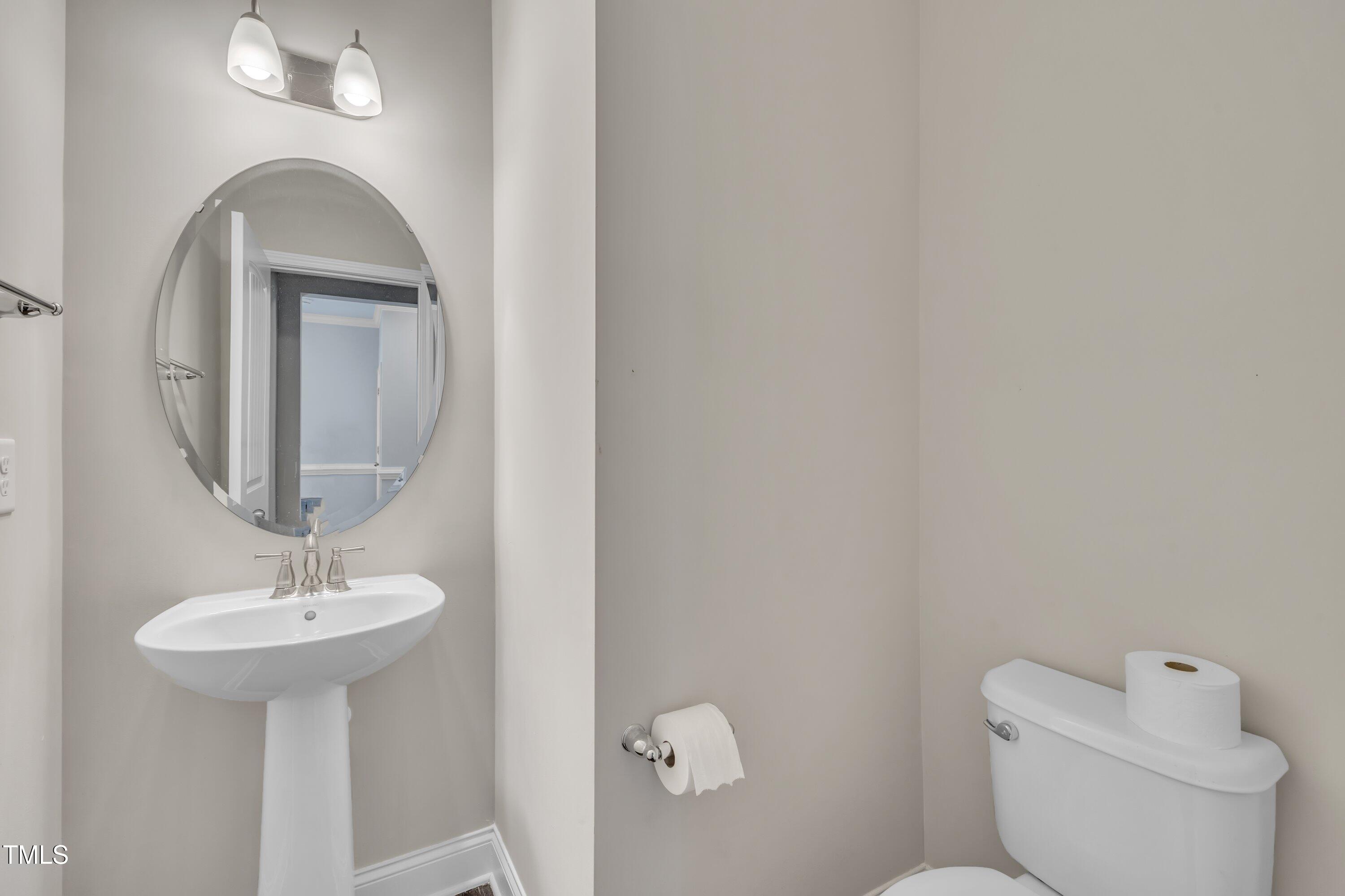 640 Newlyn Drive Raleigh, NC 27606 - Photo 8 of 44 a bathroom with a toilet sink and mirror