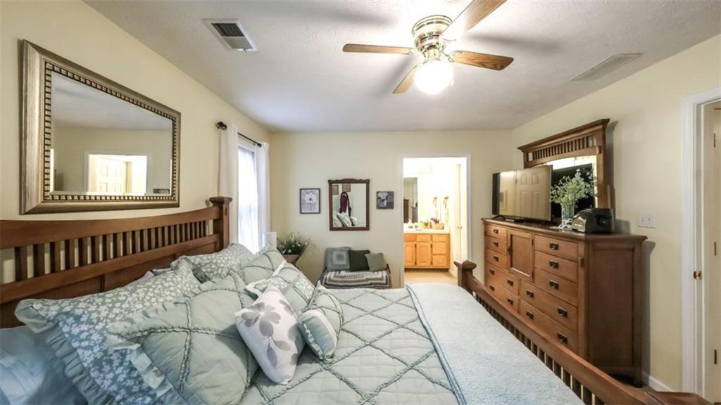 712 Honeysuckle Lane Temple, GA 30179 - Photo 16 of 46 a bedroom with furniture and a mirror