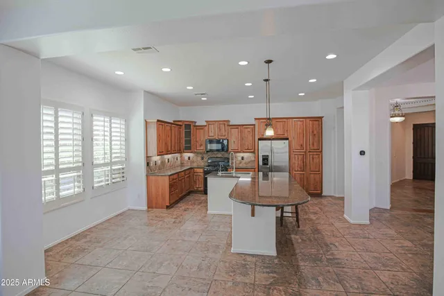 a view of an empty room with a ceiling fan