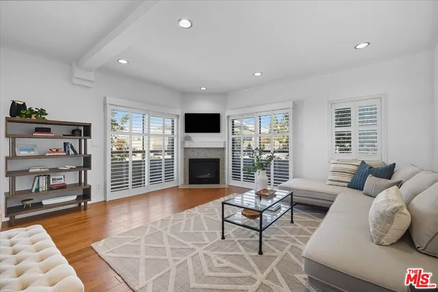 a living room with furniture large window and pool table